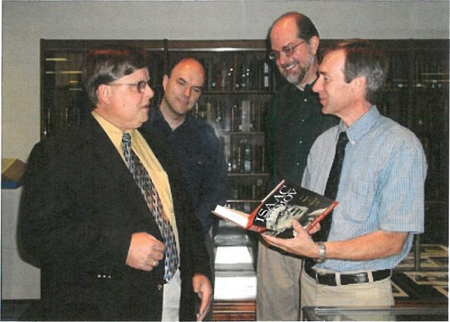Larry Shaver, Michael Ridderbusch, Harold Forbes, and John Cuthbert discuss Asimov donation.
